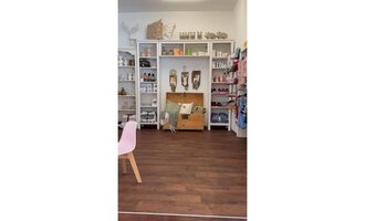A cozy shop with wooden floors and bright shelves. There are various products, including decorations and furniture pieces. | © Herzstichle | Ninja Matt