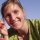Young woman smiling, wearing sunglasses on her head and a green shirt on a sunny day. | © Kleinwalsertal Tourismus eGen