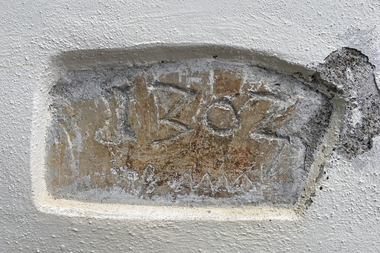 Old stone with engraved text 'IZBOZ' and illegible markings, embedded in a wall. | © Kleinwalsertal Tourismus eGen